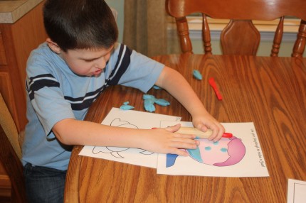 Caden playing with a Playdough Mat