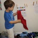 Josiah sorting laundry by color